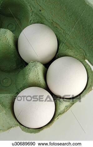 Stock Image - White eggs in green box. Fotosearch