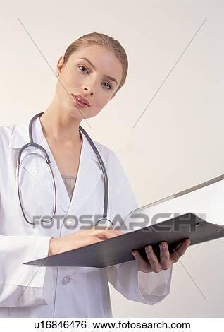 Stock Photograph - brown hair, coat, device, doctor. Fotosearch
