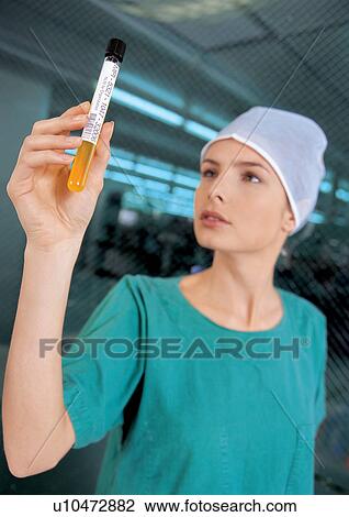Stock Image - examining, green, holding. Fotosearch