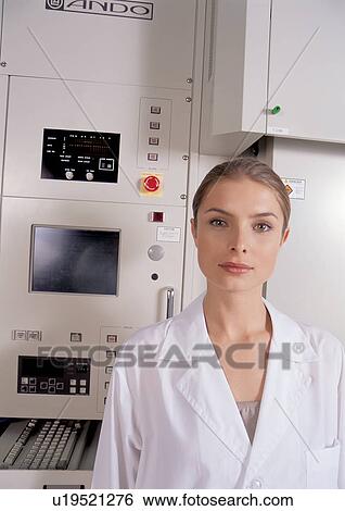 Stock Photograph - Female in front of a lab machine . Fotosearch