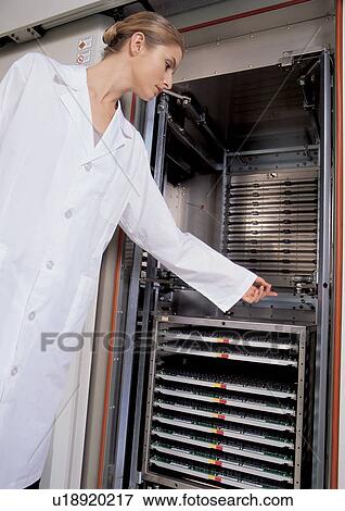 Stock Photo - lab coat, bun, young adult, device, science, coat, one person. Fotosearch