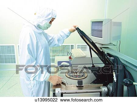 Stock Image - machine, one person, holding, r & d, examining, development. Fotosearch