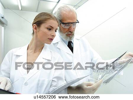 Male and female scientist examining transparent sheet View Large Photo Image Stock Photograph - Male and female scientist examining transparent sheet. Fotosearch