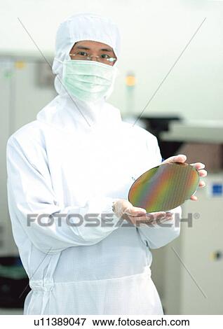 Stock Photo - Man holding technology. Fotosearch