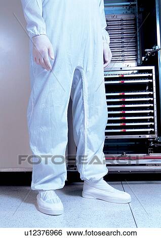 Stock Photograph - Person standing by lab equipment . Fotosearch