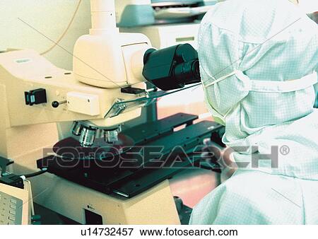 Stock Photo - r & d matters, looking through, sitting, medical equipment, working, one person, development. Fotosearch
