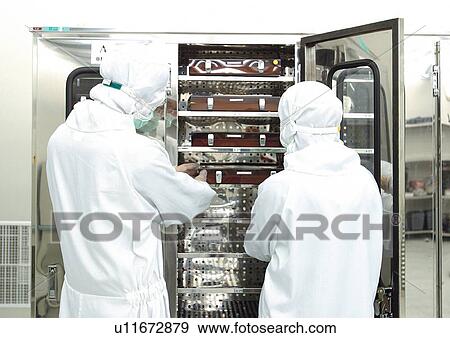Stock Photo - rear view, researchers in protective suits. Fotosearch