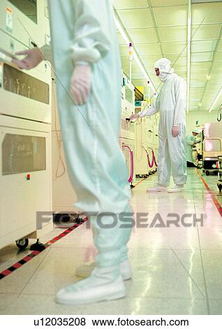 Stock Photo - Scientists conducting experiments using large machines. Fotosearch