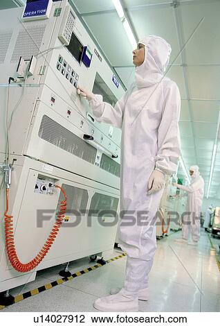 Scientists operating large machines View Large Photo Image Stock Image - Scientists operating large machines . Fotosearch