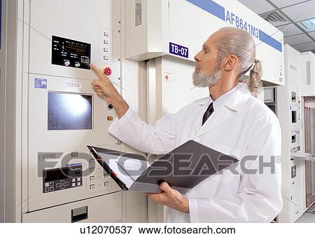 Stock Photo - standing, waist up, science, lab coat, development, grey hair, machinery. Fotosearch