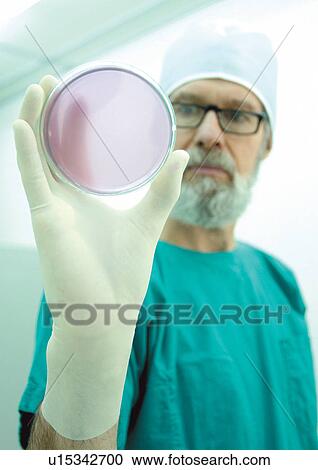 Stock Image - surgical gloves, r & d, looking at camera, round, spectacles. Fotosearch