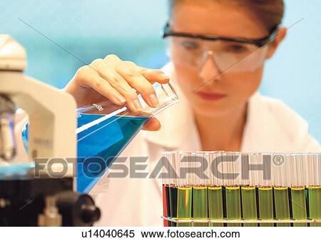 Woman filling beakers View Large Photo Image Stock Photography - Woman filling beakers . Fotosearch