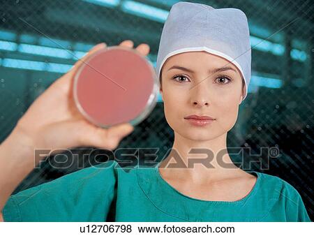 Stock Photo - Woman holding a petri dish. Fotosearch