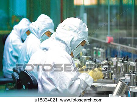 Stock Image - Workers in dust-free laboratory. Fotosearch