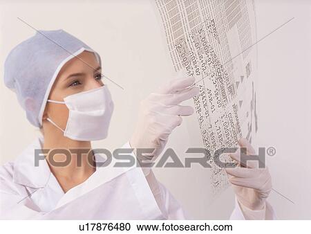 Stock Image - young adult, holding, technician, looking, development, studying, female. Fotosearch