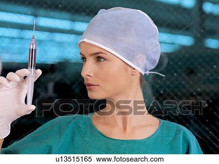 Stock Photography - young adult, surgical scrubs, culture, r&d matters, holding, indoor. Fotosearch