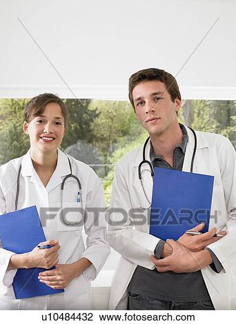 Stock Image - Doctors holding files. Fotosearch