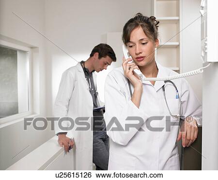 Doctors on the phone View Large Photo Image Stock Photograph - Doctors on the phone. Fotosearch