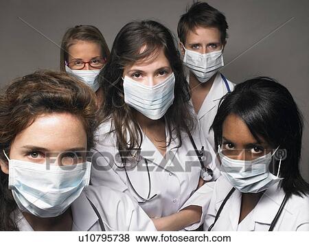 Group of young doctors wearing masks View Large Photo Image Stock Photo - Group of young doctors wearing masks. Fotosearch