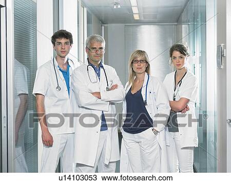 Group shot of four doctors in hospital lobby. View Large Photo Image Stock Image - Group shot of four doctors in hospital lobby.. Fotosearch