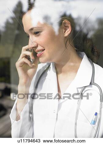 Young female doctor on the phone View Large Photo Image Stock Image - Young female doctor on the phone. Fotosearch