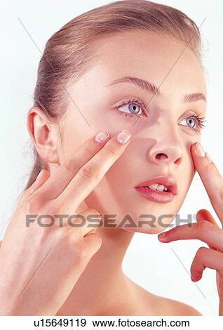 Stock Photo - applying, close-up, care, beauty treatment, adoring. Fotosearch