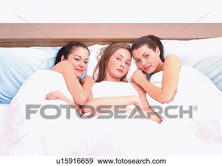 Stock Photo - bed, carefree, friends, happy. Fotosearch