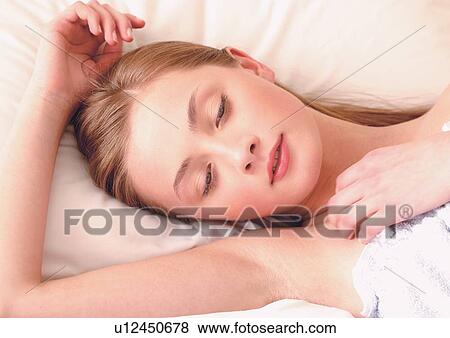 Stock Photo - bed, close-up, looking down, one person. Fotosearch