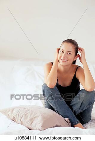 Stock Image - happy, looking at camera, portrait, sitting. Fotosearch