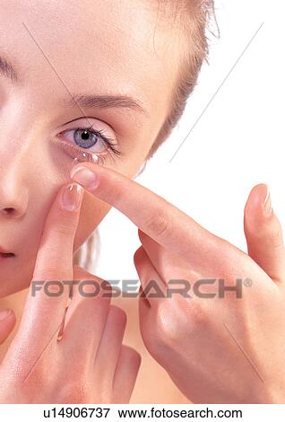 Stock Photo - human face, health, woman, looking at camera, white background, optical device, one person. Fotosearch