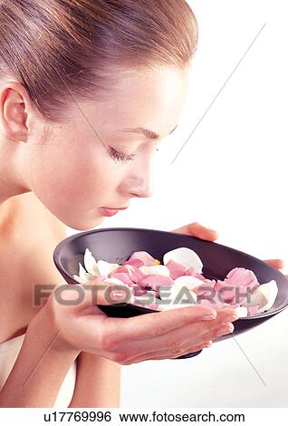 Stock Photograph - woman, person, petals, beautification, holding. Fotosearch