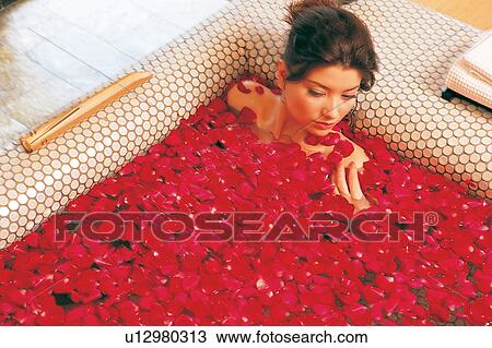 Stock Image - Bathroom, Bathtub, Brown Hair, Clothes. Fotosearch