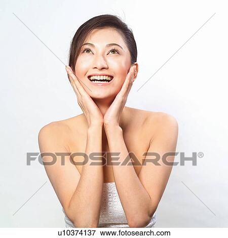 Stock Photo - Real People, Female feature, woman feature, Thinking, Young Adult, Feature. Fotosearch