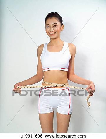 Standing, Waist Measure, Black Hair, Beauty, Holding, Instrument Of Measurement View Large Photo Image Stock Photograph - Standing, Waist Measure, Black Hair, Beauty, Holding, Instrument Of Measurement. Fotosearch