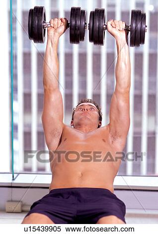 dumb bells, activity, bending backwards, exercising machine, fitness gym, exercising View Large Photo Image Stock Photography - dumb bells, activity, bending backwards, exercising machine, fitness gym, exercising. Fotosearch