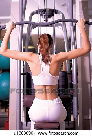 Stock Photo - indoor, woman, body, hands in air, strength, sitting. Fotosearch