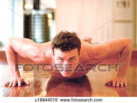 Stock Photo - looking at camera, bare chest, energy, male, strength, physical exertion. Fotosearch