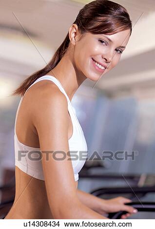 Picture - power, cheerful, smiling, physical exertion, exercise machine, culture. Fotosearch