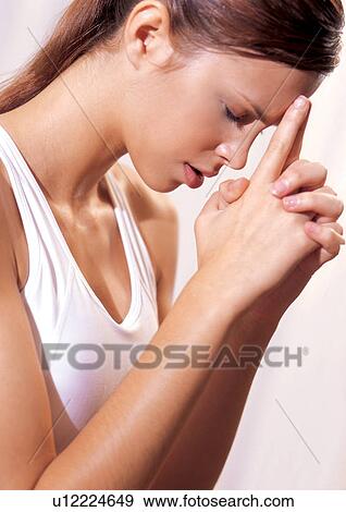 Stock Photo - Woman thinking about working out. Fotosearch