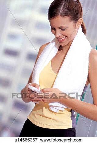 Stock Photo - Working out woman texting . Fotosearch
