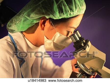 Stock Image - Close-Up, Device, Colored Background, Asian Ethnicity. Fotosearch
