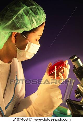 Stock Photo - Looking Down, One Person, Surgical Mask, Equipment. Fotosearch