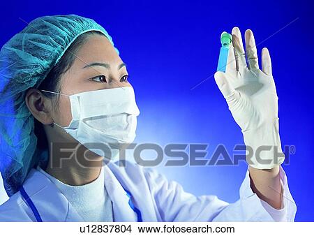 Picture - Scientific Experiment, Scientist, Looking Up, Surgical Mask, Surgical Cap. Fotosearch