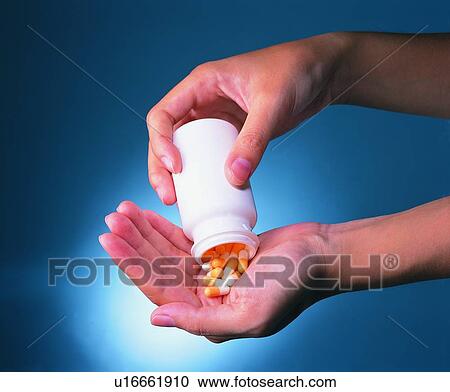 Stock Image - Medication, Medicine, Back Lit, Human Hand. Fotosearch