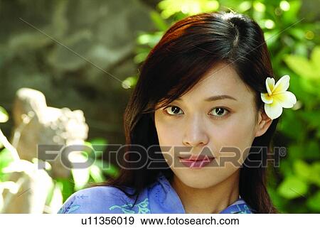Stock Photo - Portrait, Beauty, Wearing Flowers, Day, One Person, Head And Shoulders, Attitude. Fotosearch