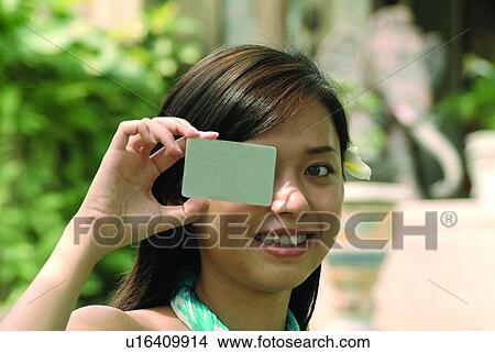 Young Adult, Focus On Foreground, Looking Away, Toothy Smile, Placard View Large Photo Image Picture - Young Adult, Focus On Foreground, Looking Away, Toothy Smile, Placard. Fotosearch
