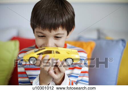 Boy playing with toy car View Large Photo Image Stock Image - Boy playing with toy car. Fotosearch