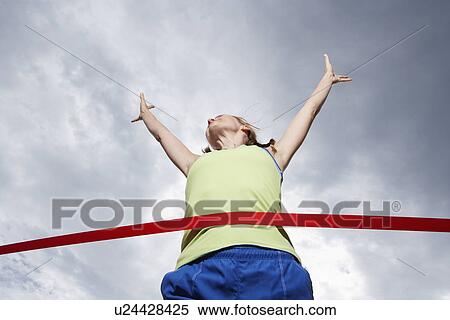 Female runner crossing finishing line (low angle view) View Large Photo Image Stock Photography - Female runner crossing finishing line (low angle view). Fotosearch