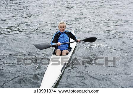 Mature woman kayaking View Large Photo Image Picture - Mature woman kayaking. Fotosearch