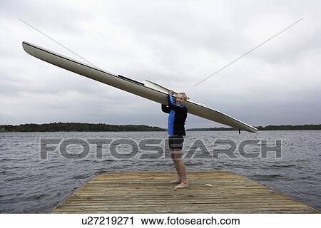 Stock Image - Middle-Aged Woman with Kayak Standing by Lake. Fotosearch